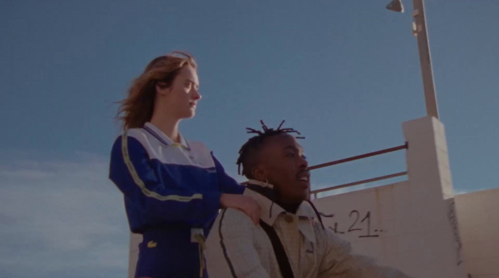 a man standing next to a woman in front of a building