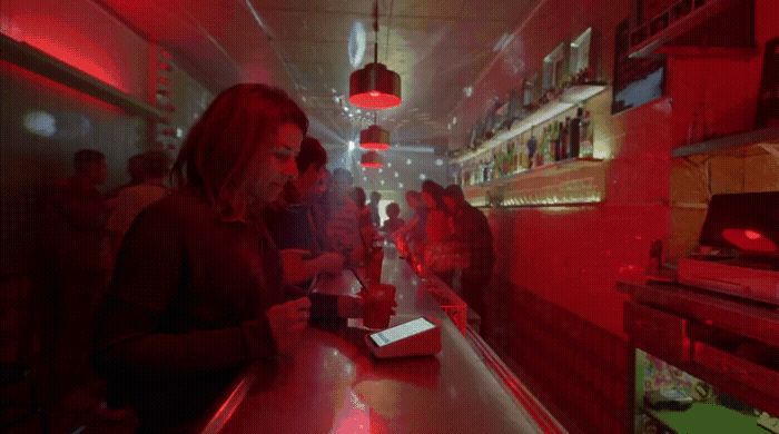 a group of people standing around a bar