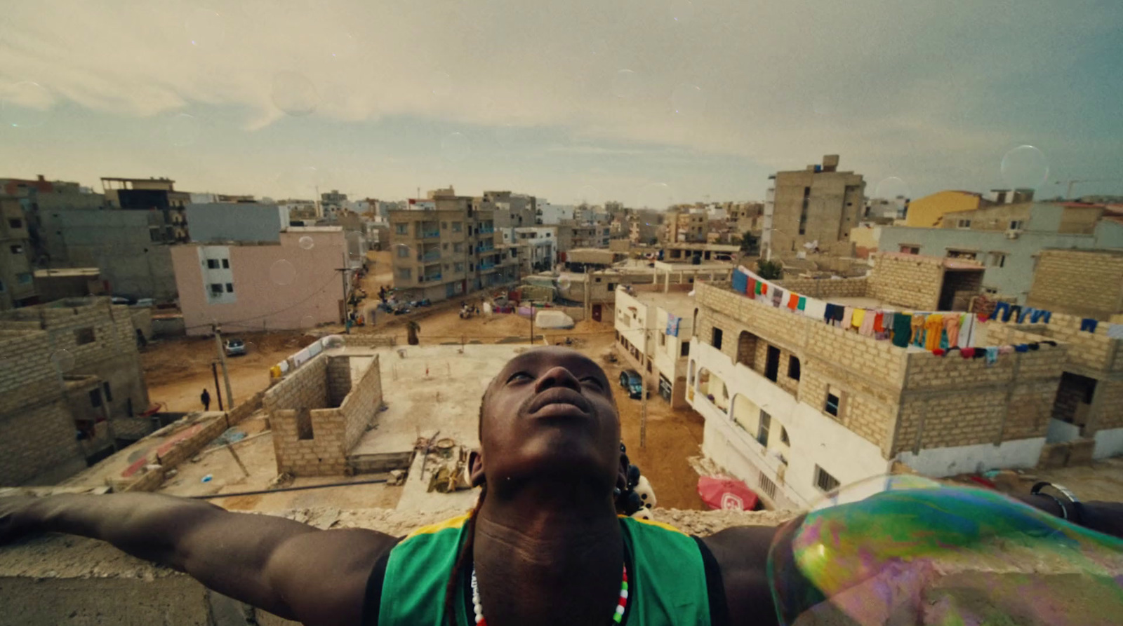 a man standing on top of a roof next to a building