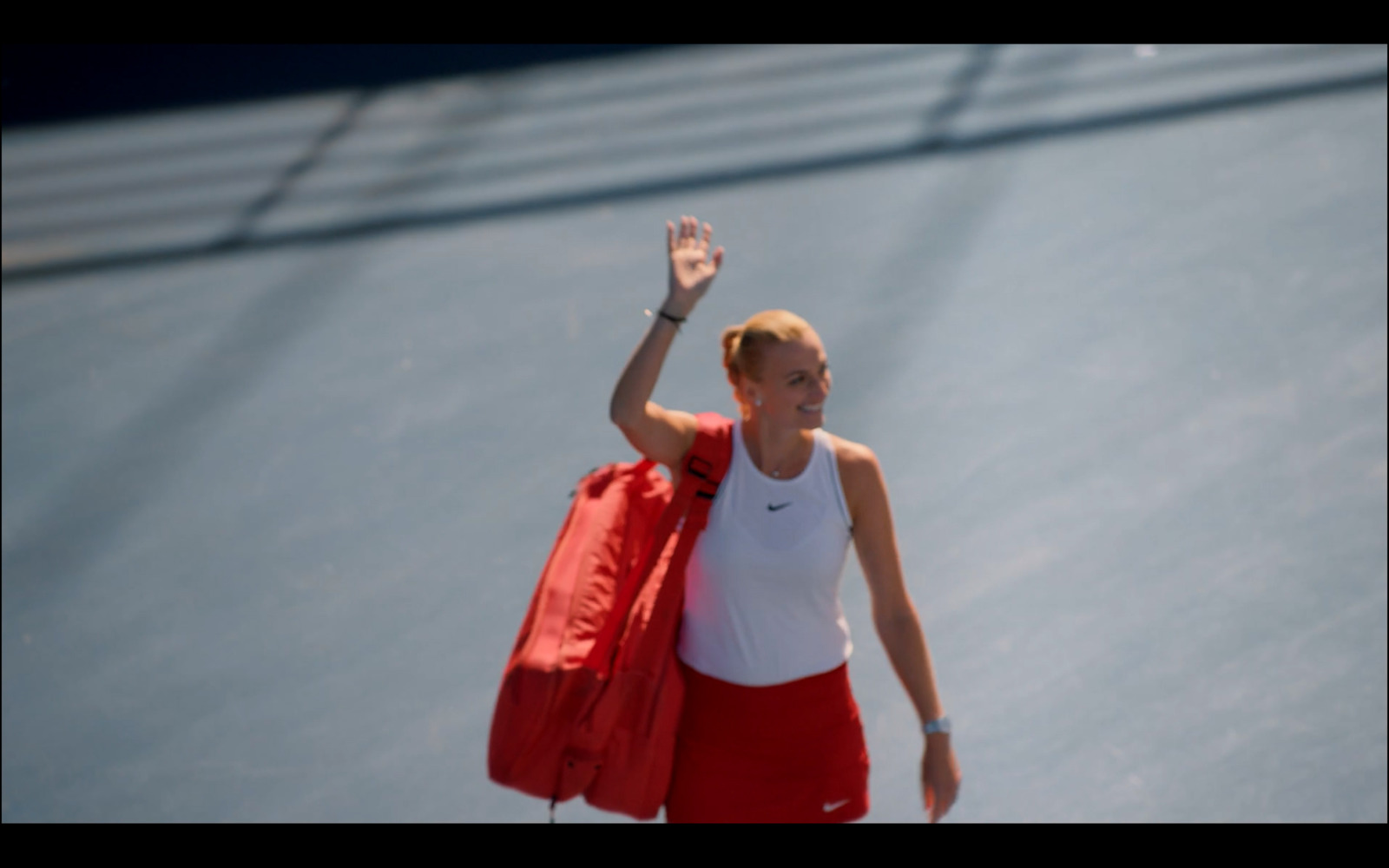 a woman holding a tennis racquet on a tennis court