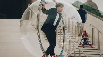 a man in a suit is walking in a bubble