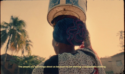 a woman with blue hair and a hat on her head