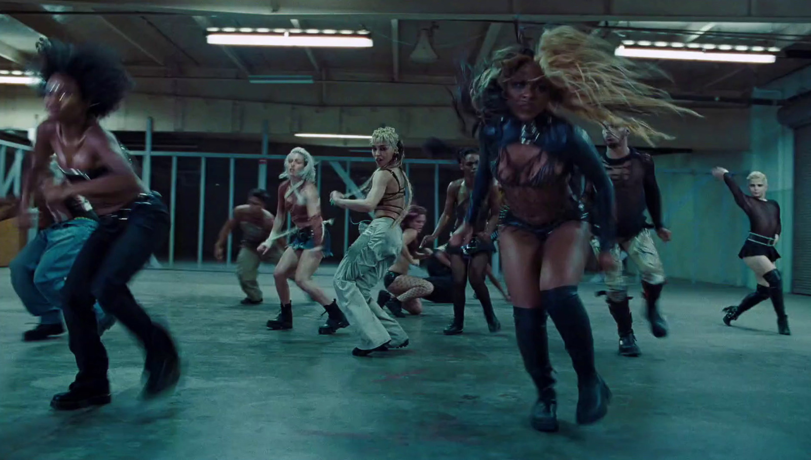 a group of women dancing in a warehouse