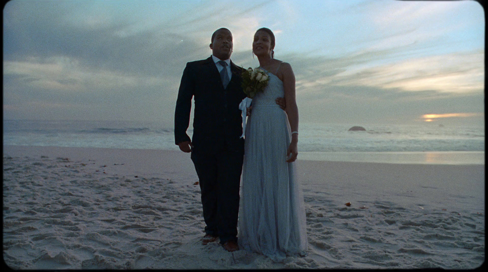 a man and a woman standing on a beach