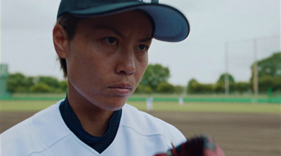 a woman in a baseball uniform holding a baseball bat