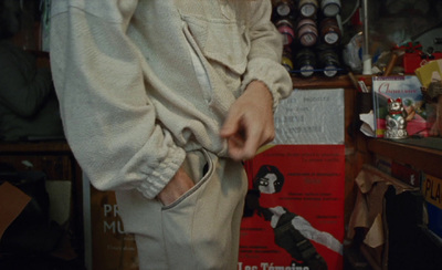 a person standing in a room with many items on the shelves