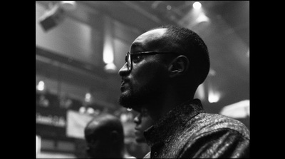 a black and white photo of a man with glasses