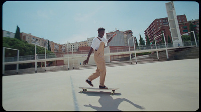 a man riding a skateboard down a street