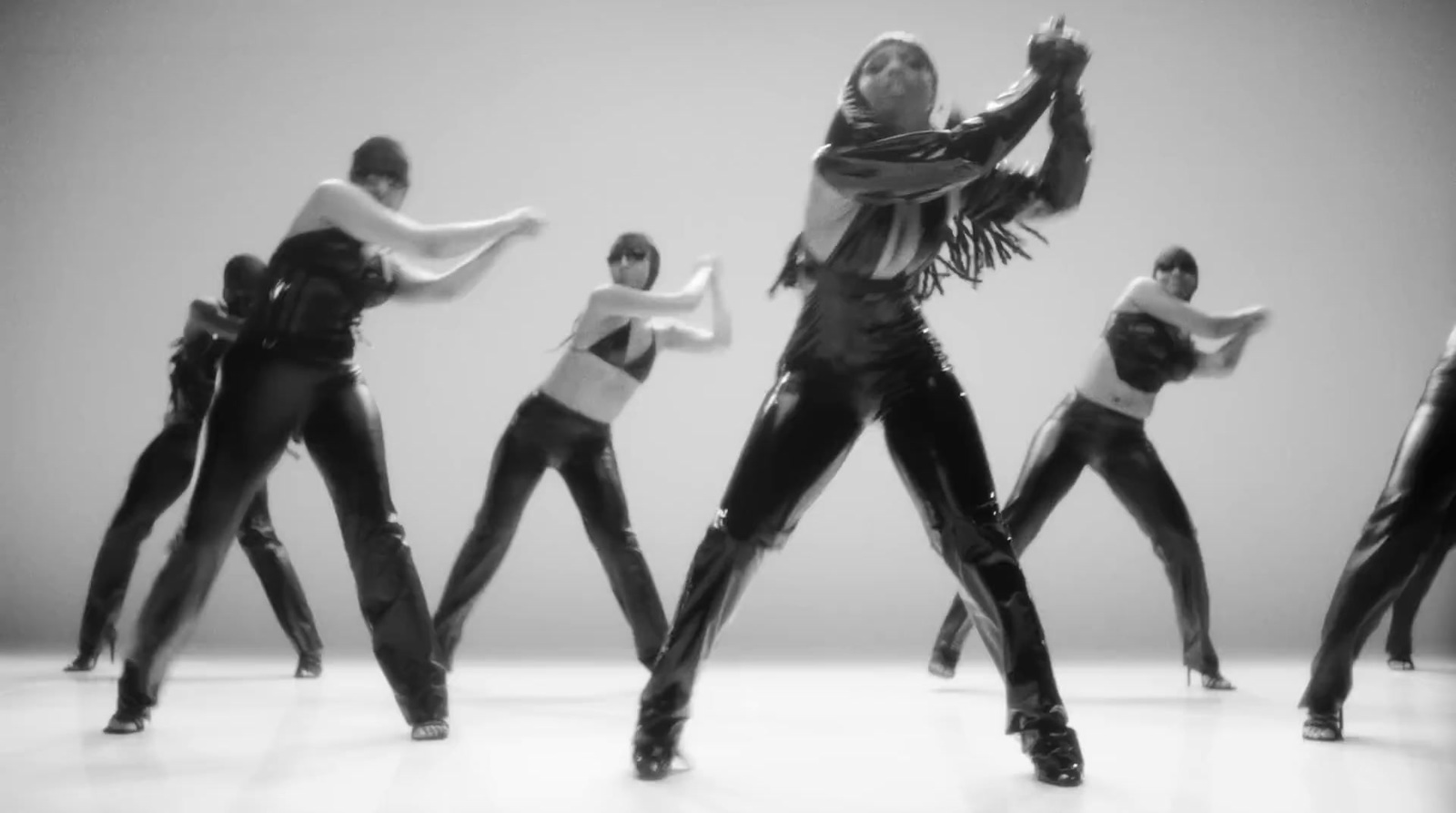 a group of women in black and white dancing