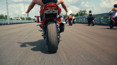 a group of people riding motorcycles down a road