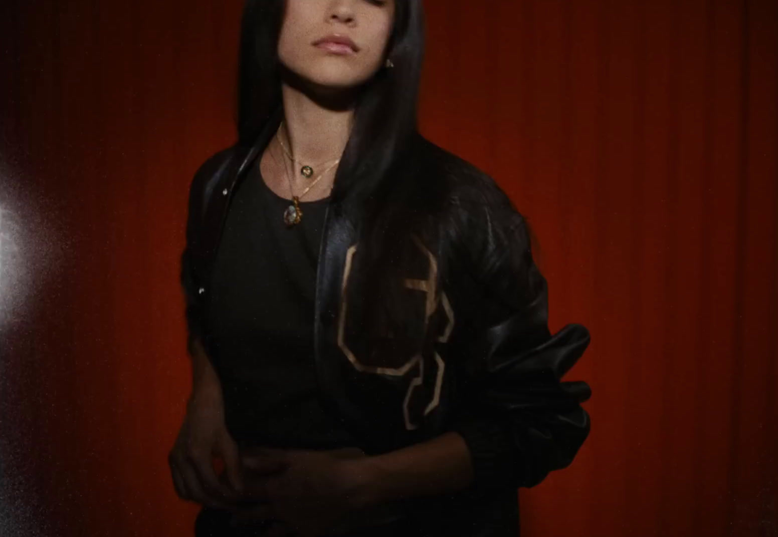 a woman standing in front of a red wall