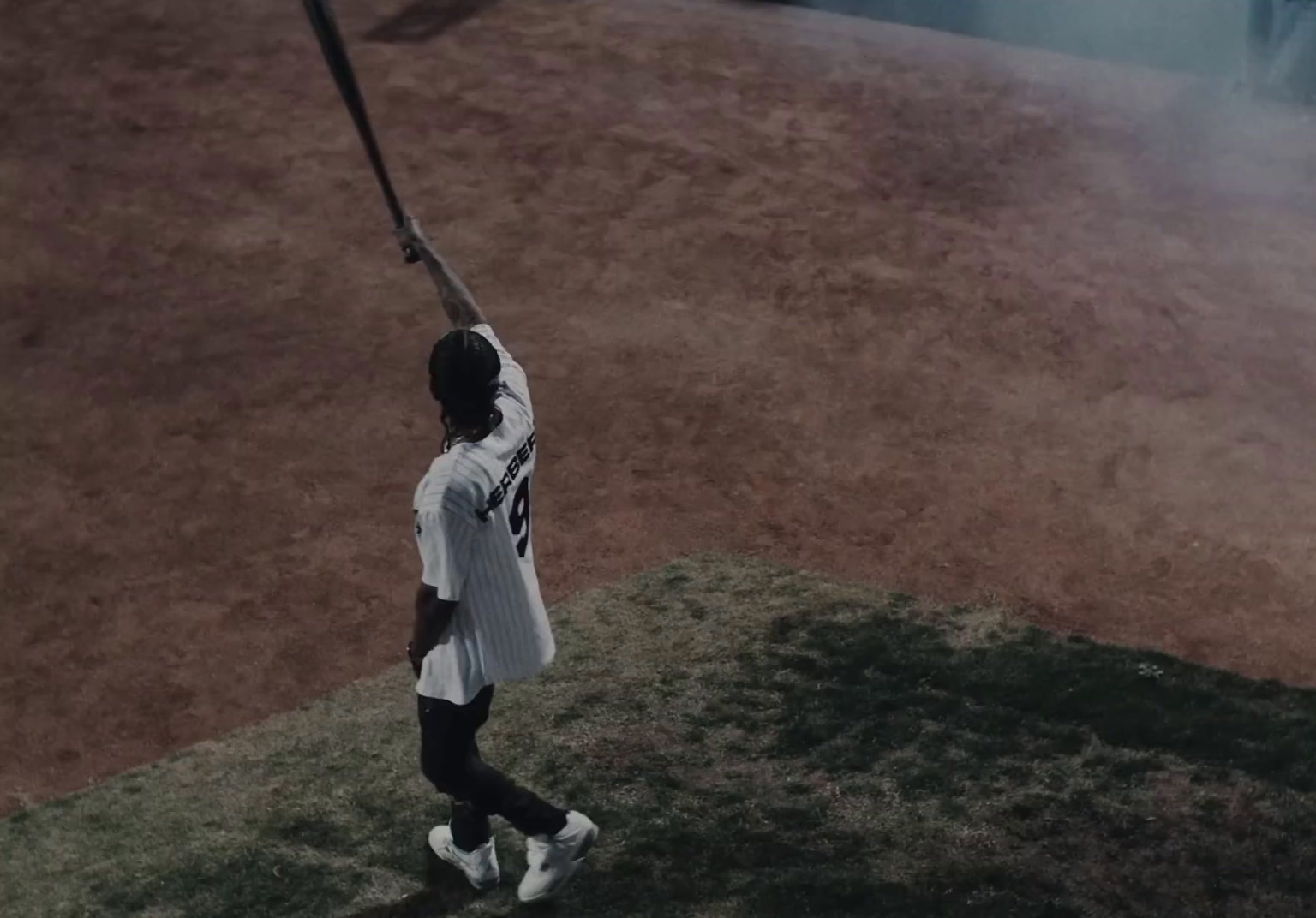 a man holding a baseball bat on top of a field