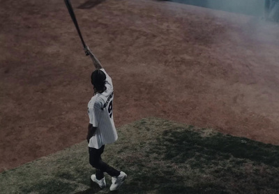 a man holding a baseball bat on top of a field