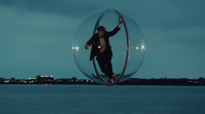 a man is balancing on a large object in the water