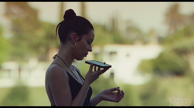 a woman holding a cell phone in her right hand