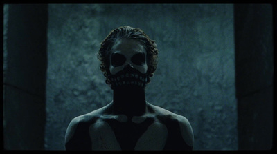 a man with a skeleton face painted on his chest