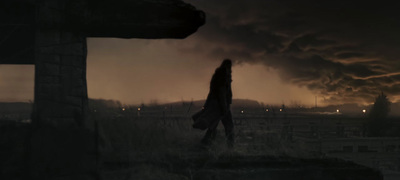 a person walking through a field at night