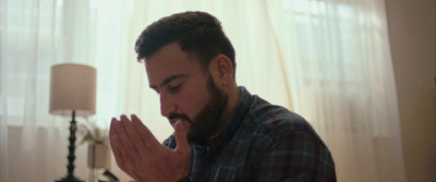 a man with his hands folded in prayer