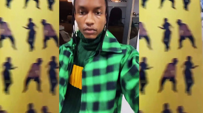 a young man wearing a green and yellow shirt