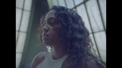 a close up of a person with curly hair