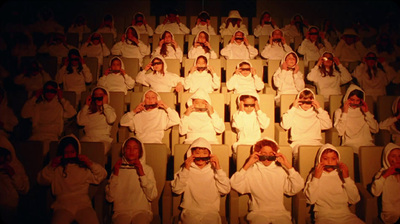 a group of people sitting in rows of chairs