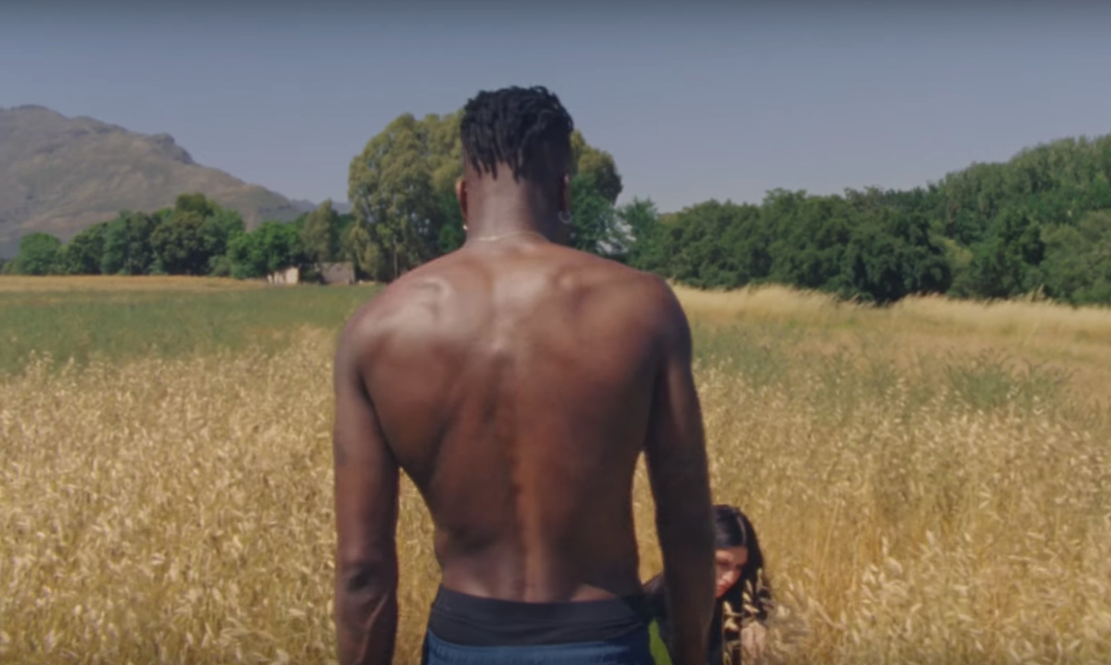 a man standing in a field of tall grass