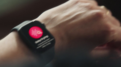 a close up of a person wearing a smart watch