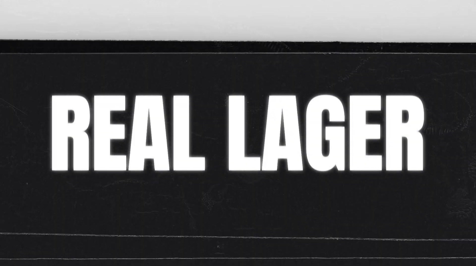 a black and white photo of a real lager sticker