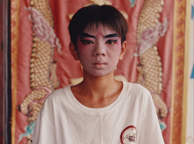 a young man with black and white face paint