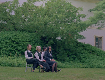 a group of people sitting on top of a wooden bench