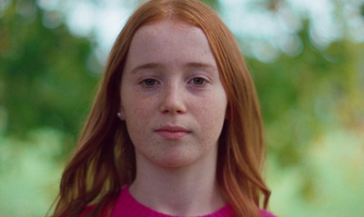 a close up of a person with red hair