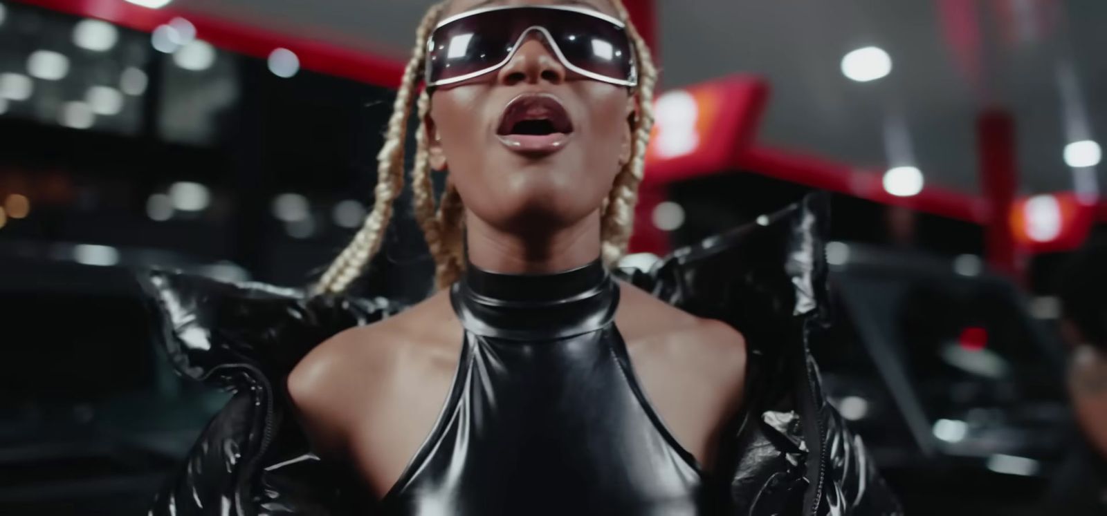 a woman in a leather outfit and sunglasses