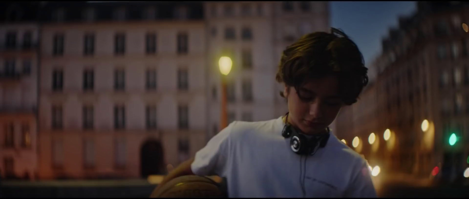 a man wearing headphones standing in front of a building