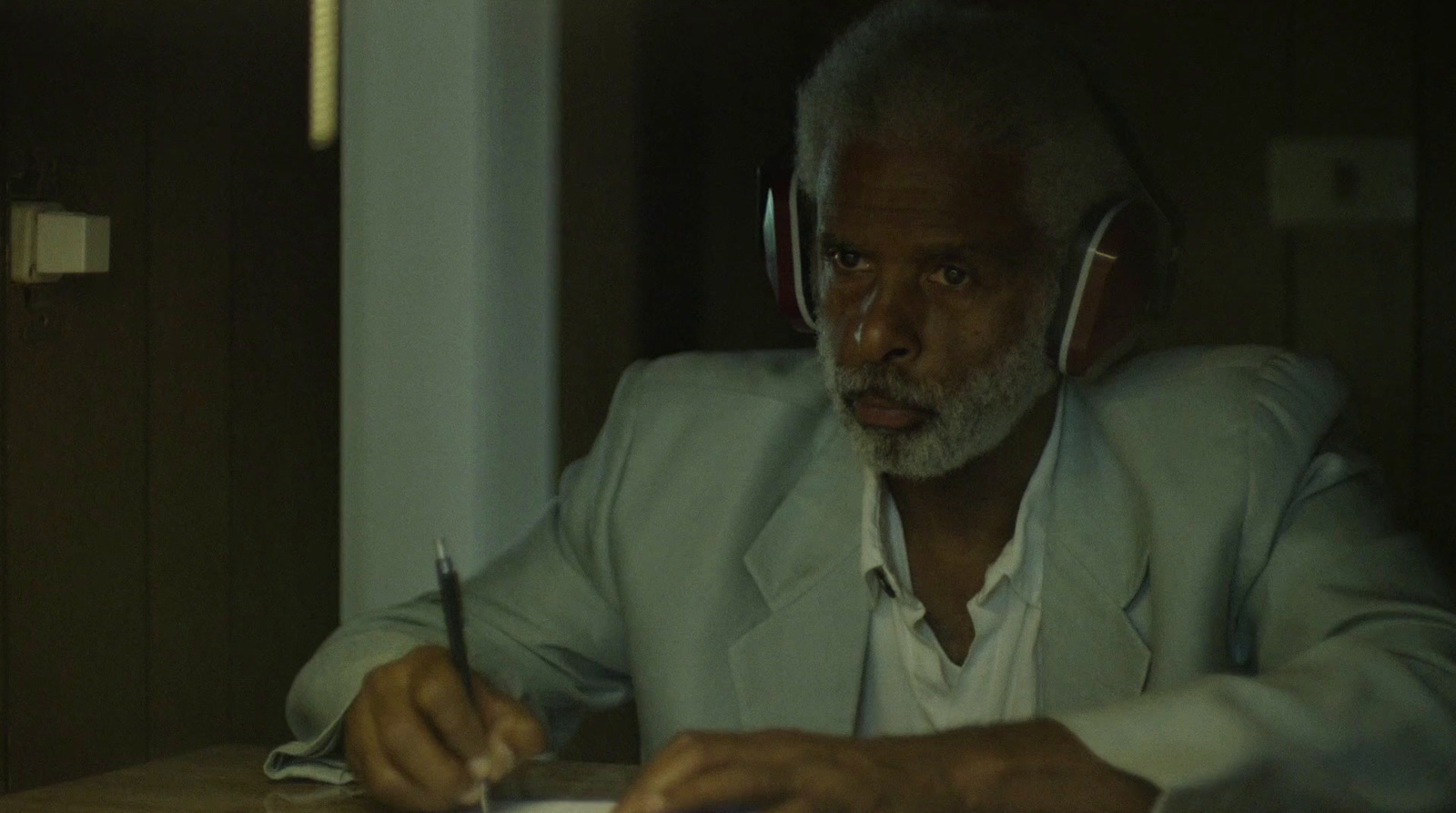 a man sitting at a table with headphones on