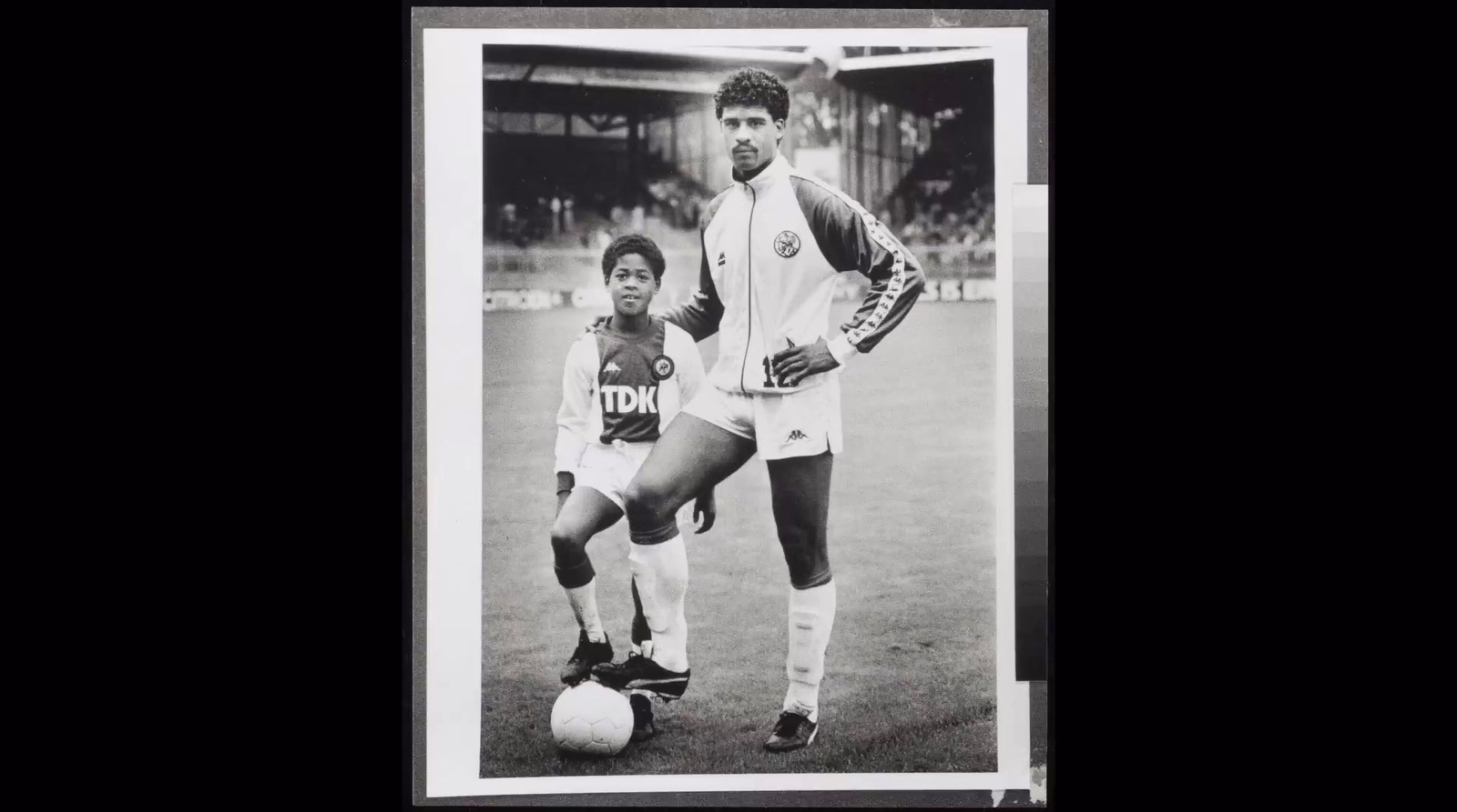 a black and white photo of two soccer players