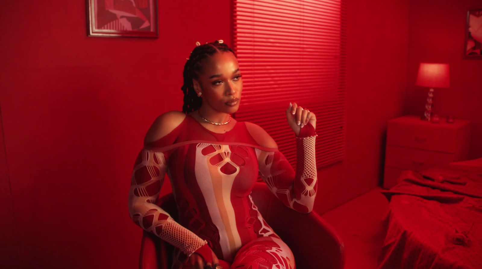 a woman in a red room with a red light