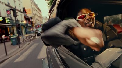 a man in a car with sunglasses on