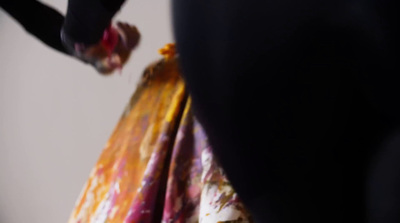 a close up of a person's hand holding a dress