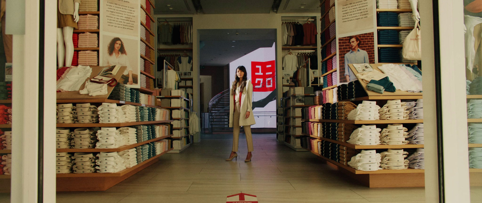 a woman is standing in the middle of a book store