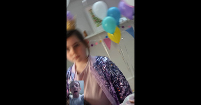 a blurry photo of a woman in a room with balloons