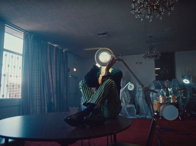 a person sitting on a table with a fan over their head