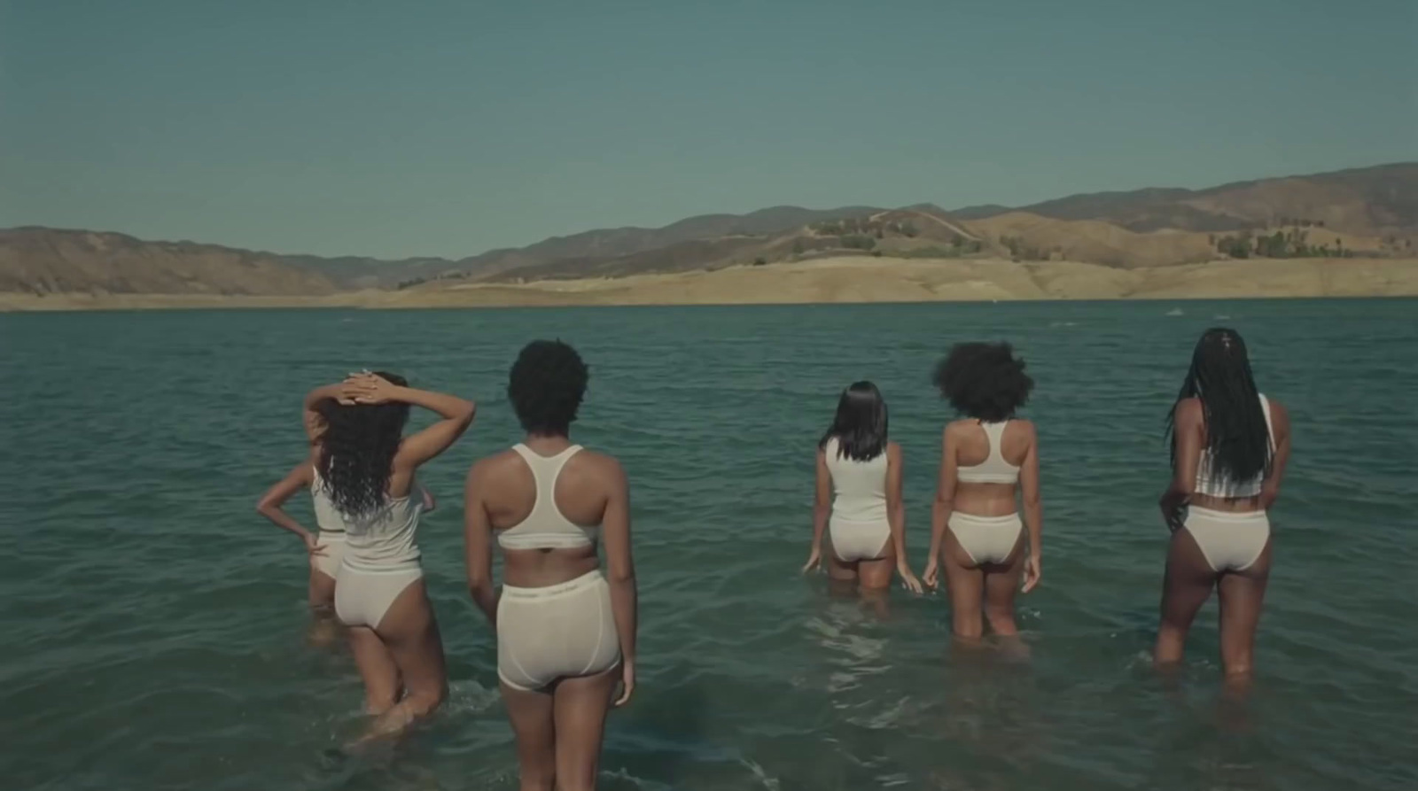 a group of women standing in the water