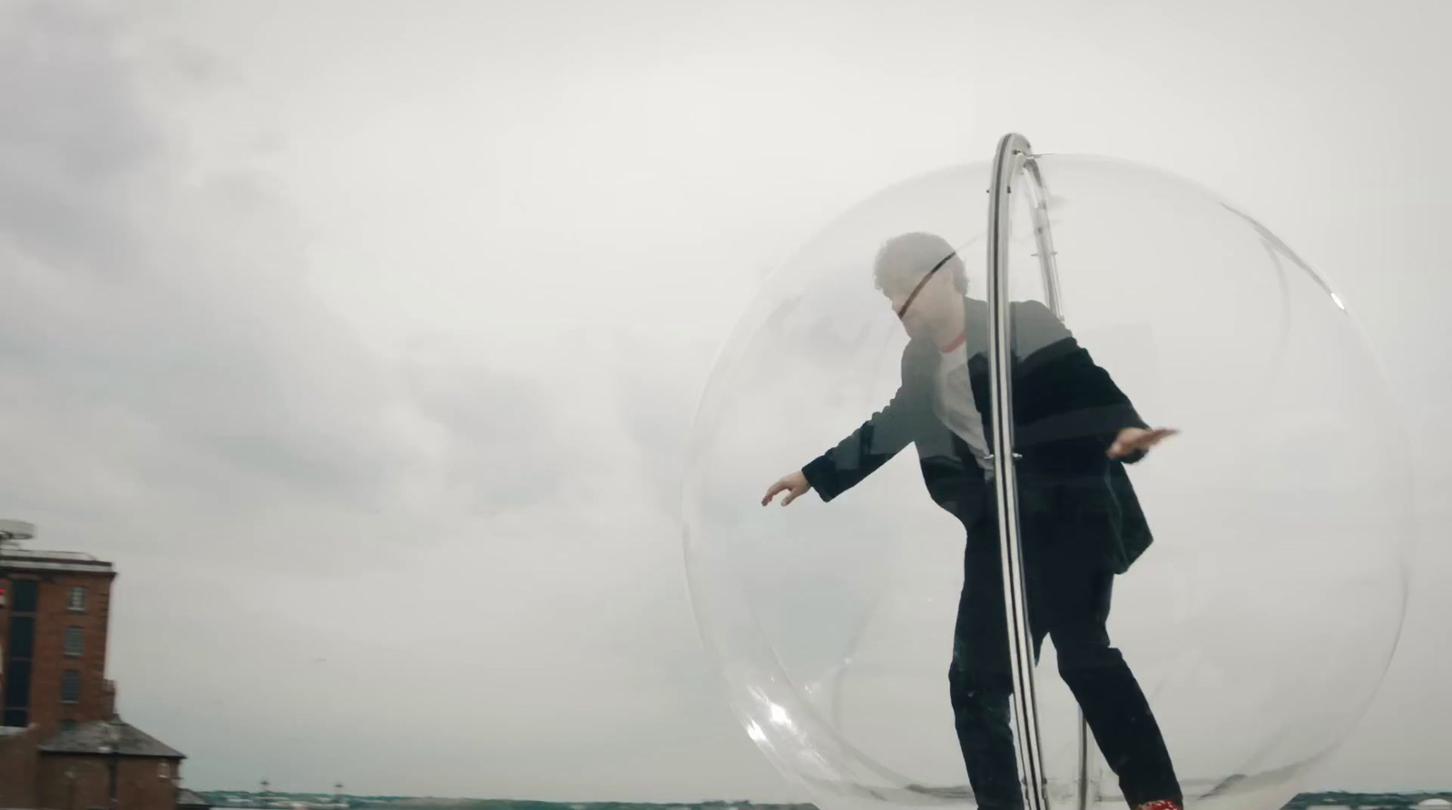 a man in a suit is balancing in a bubble