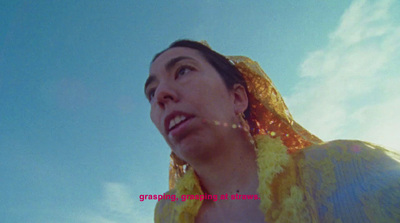 a woman in a yellow dress looking up at the sky