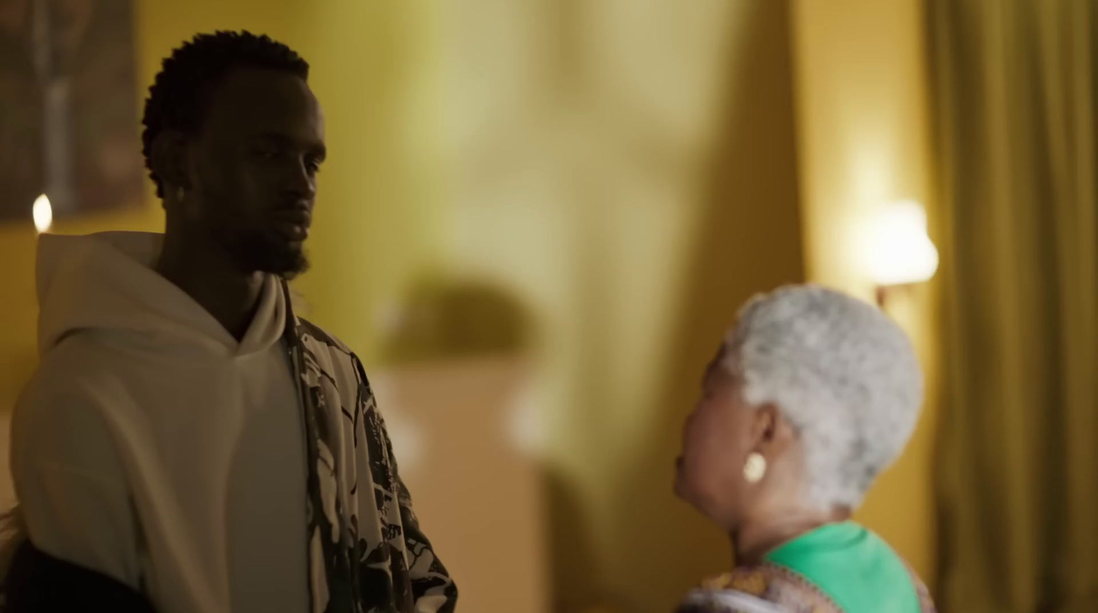 a man standing next to a woman in a living room