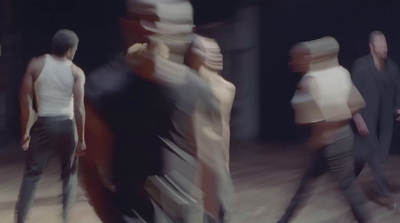 a blurry image of a group of people walking down a street