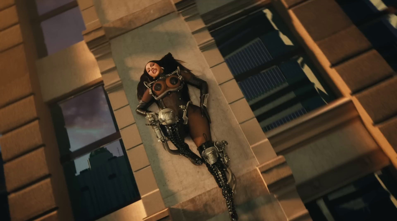 a woman in a bodysuit laying on a building