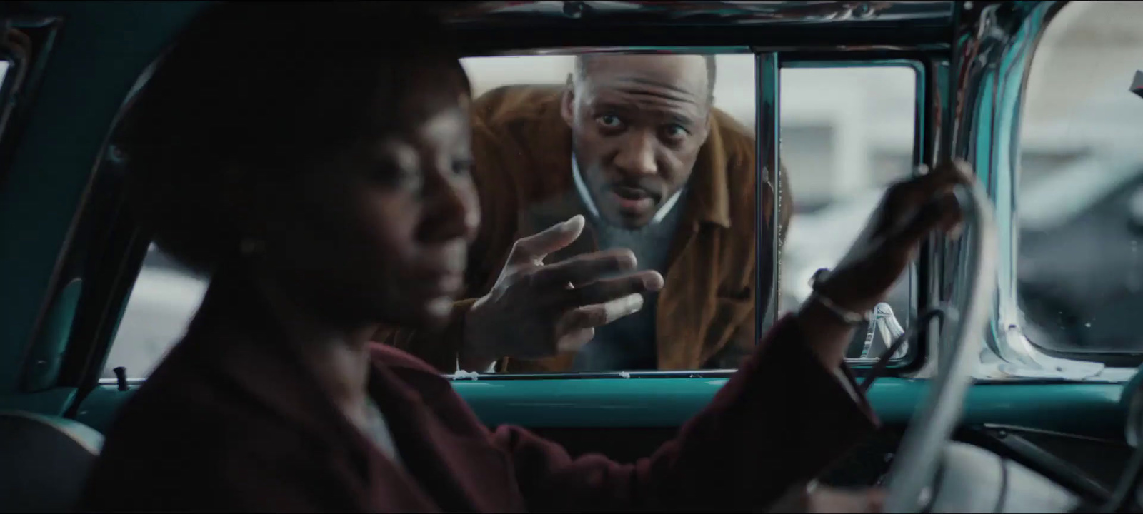 a man and a woman sitting in a car