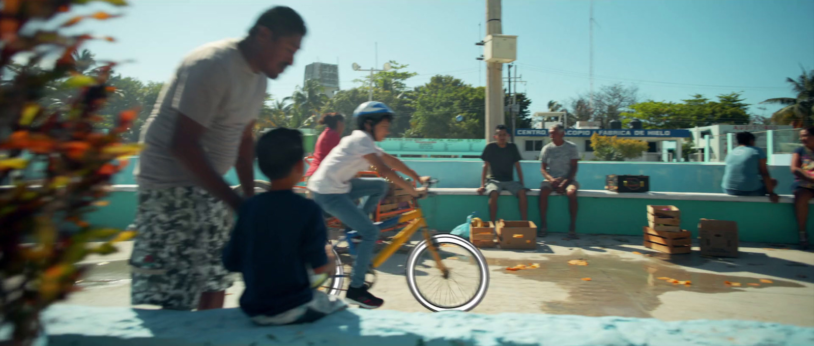 a man riding a bike next to a group of people