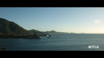 a plane is flying over a body of water